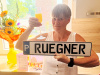 Elke Rügner mit einem Sekt-Glas und ihrem Parkschild in den Händen